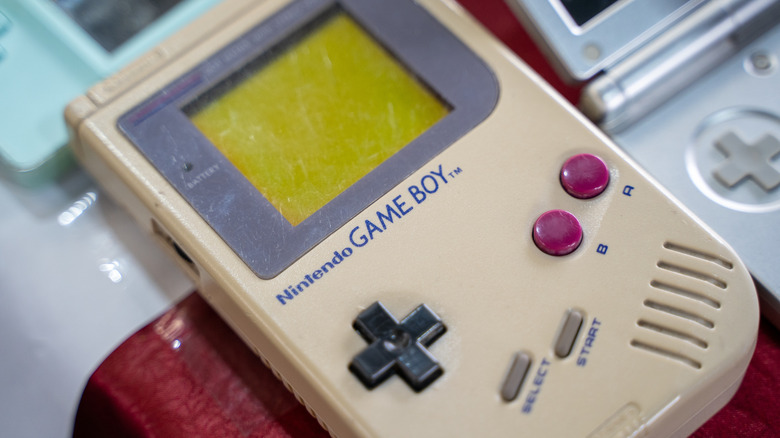 Vintage Nintendo Game Boy next to other devices