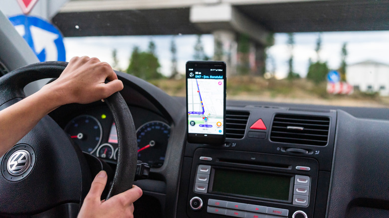 A driver following the directions on the Waze app on their phone.