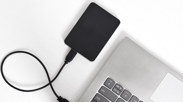 A USB hard drive connected to a laptop.