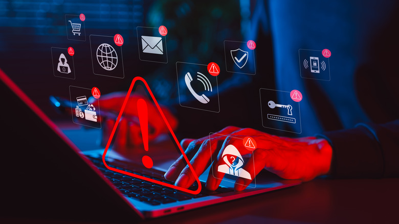 A shadowy person types on a keyboard as various symbols related to cybersecurity float around.