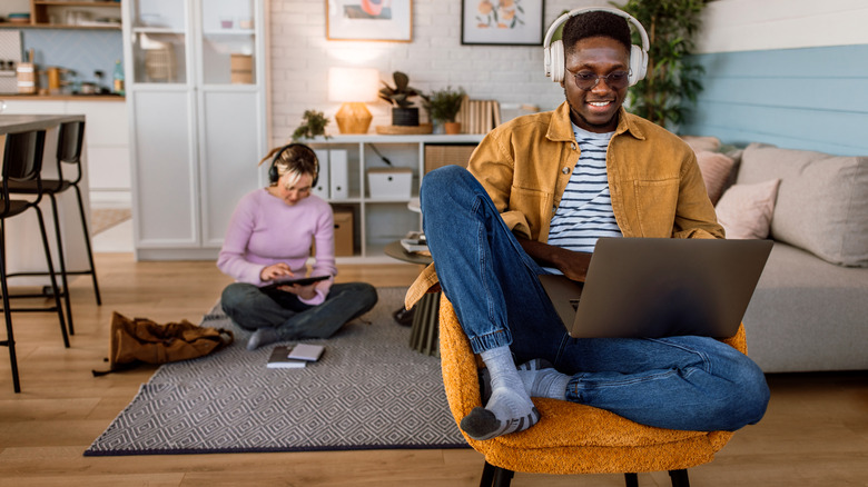 A modern home scene where multiple people use devices simultaneously.