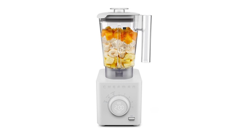 The Chefman Obliterator blender with fruit inside, on a white background.