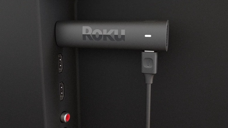 The Roku Streaming Stick 4K streaming device, plugged into an HDMI port of a TV.