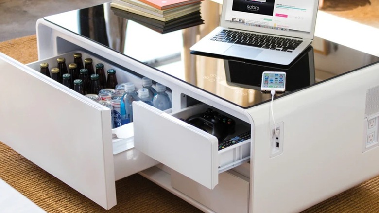 The Sobro Smart Coffee Table with bottles of drinks in the cooling drawer.