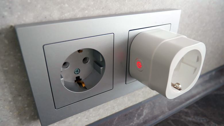 A smart plug plugged into a wall socket
