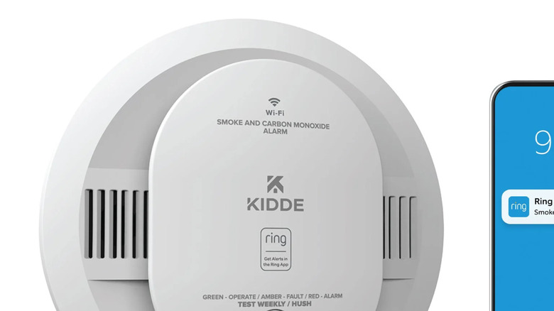 Kidde smart smoke detector with a picture of the alert on a phone