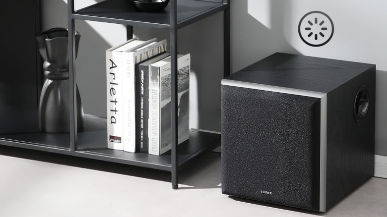 Edifier T5 placed beside a shelf of books and vase.