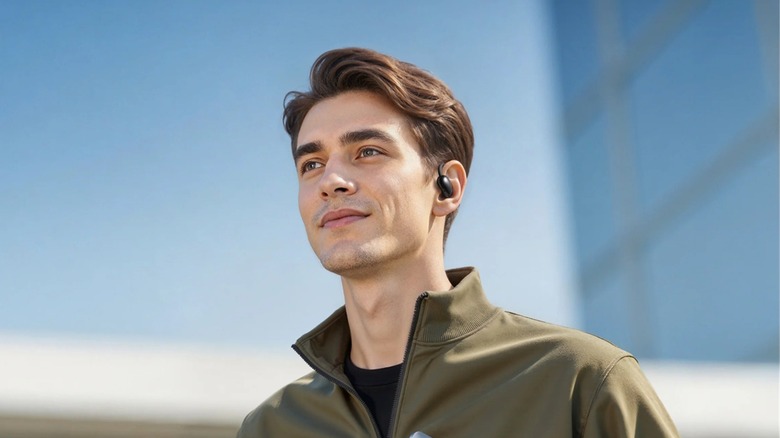 A man wearing the Soundcore Aerofit 2 AI Assistant wireless earbuds.