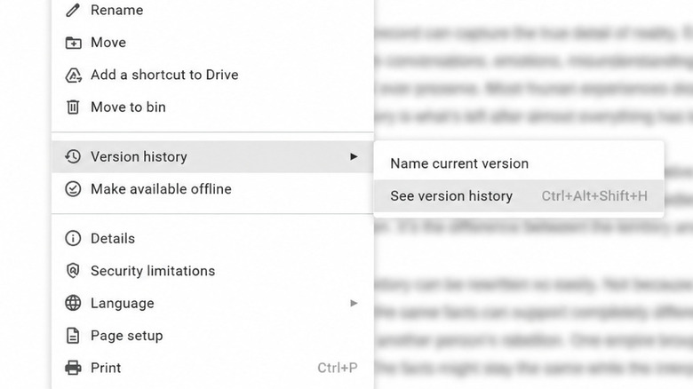 A Google Docs window with the File menu open and the Version history submenu visible; document text is intentionally blurred.