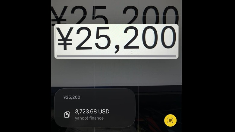 The iPhone Camera app showing a currency conversion from Japanese yen to U.S. dollar.
