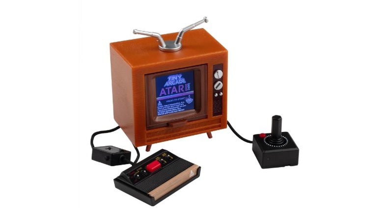 An Tiny Arcade Atari 2600, a tiny version of the Atari 2600 home console, against a white background.