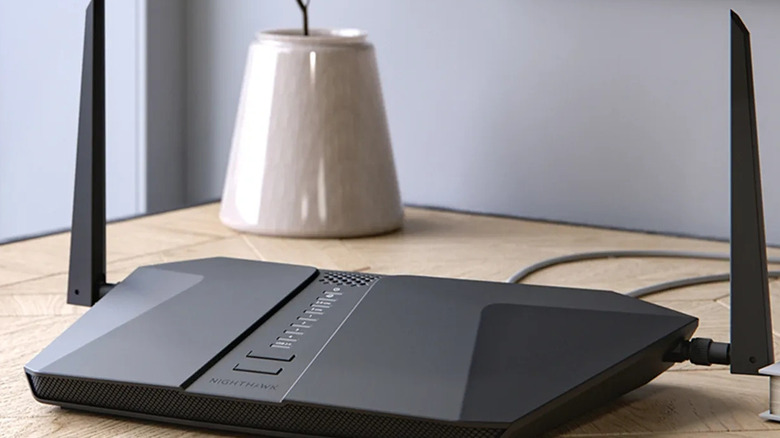 The Netgear Nighthawk AX4 router on a wooden table