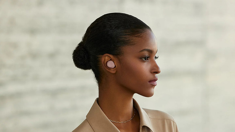 A person wearing the Sony WF-C710N earbuds
