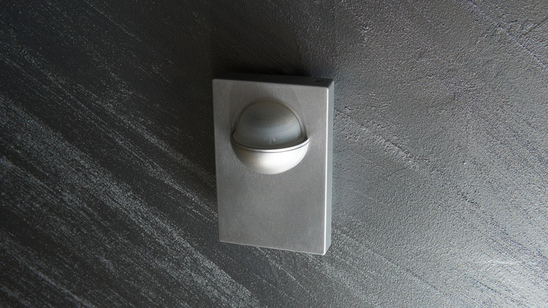 A wall-mounted passive infrared (PIR) motion sensor used to detect movement for smart lighting, home automation, or security systems.