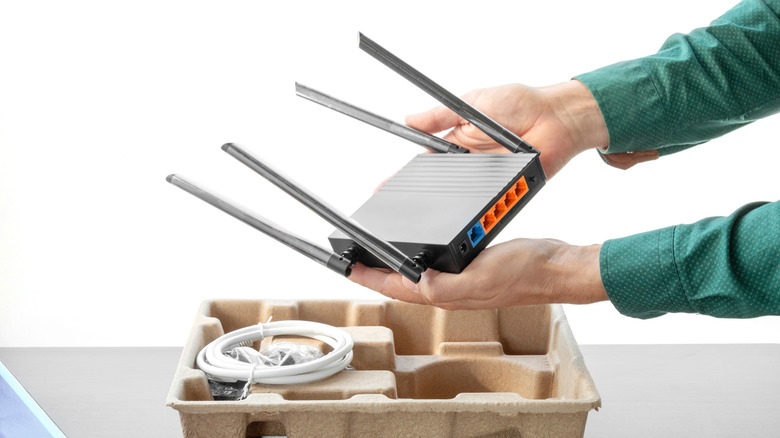 Someone holding a black router