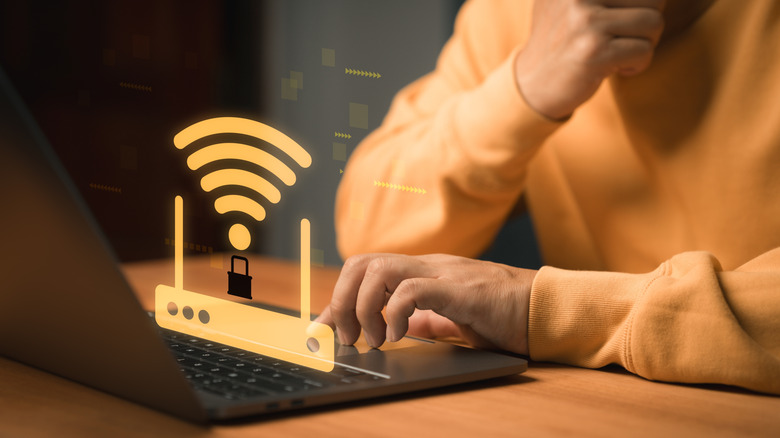 Someone using a laptop with a Wi-Fi icon hovering on top