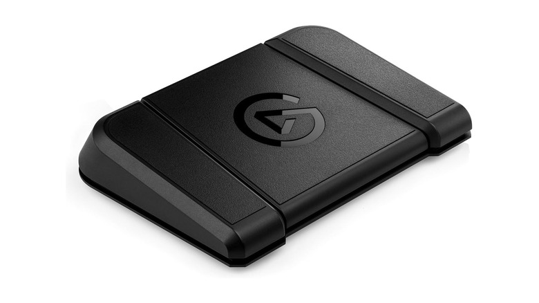 A black foot pedal on a pure white background.