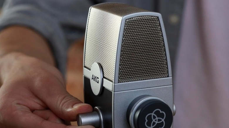The AKG Pro Audio Lyra vintage-style USB microphone on a silver stand against a white background.