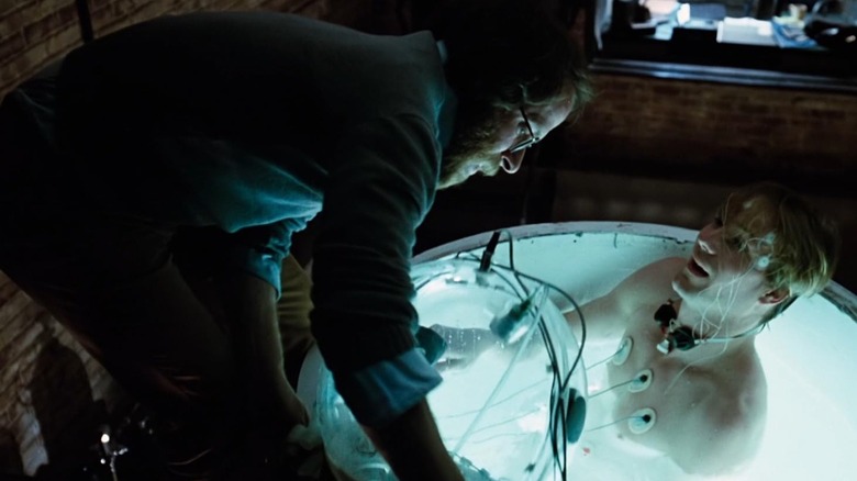 Screenshot from movie Altered States featuring character being removed from isolation tank