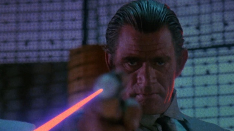 Screenshot from movie Trancers featuring character firing laser weapon