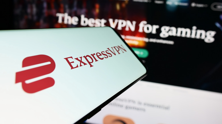 ExpressVPN logo on a phone with the homepage on the background