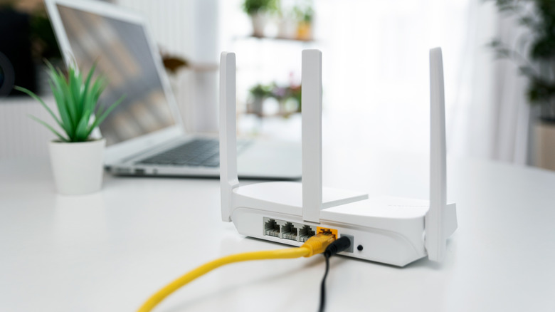 A WiFi router near a laptop