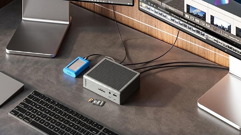 Space grey dock connected to multiple monitors and accessories, enabling a sleek desk setup.