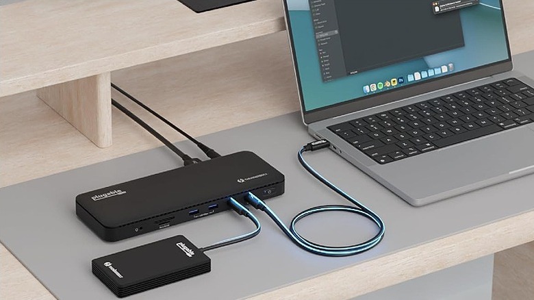 Black dock connected to a laptop and an external accessory.