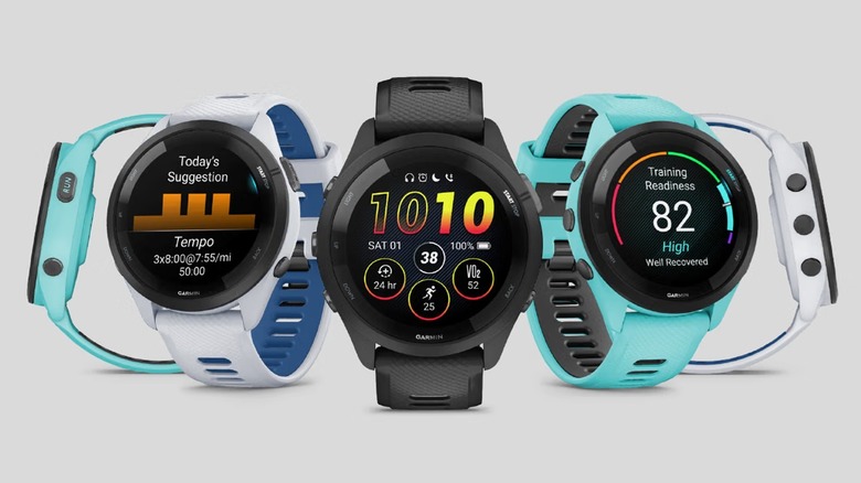 Different faces and functions of the Garmin Forerunner 265 smartwatch, on a gray background.