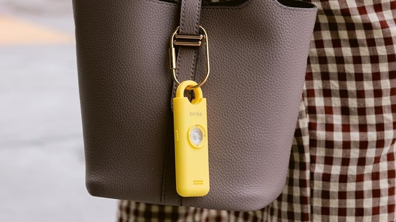 The She's Birdie 3.0 personal safety alarm attached to a bag.