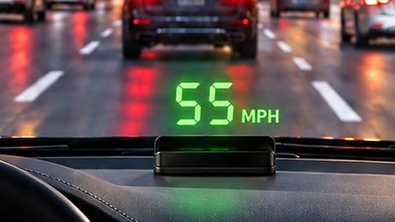 The Kuoweihud K1 heads up display installed on a car's dashboard, with the speed shown on the windshield.