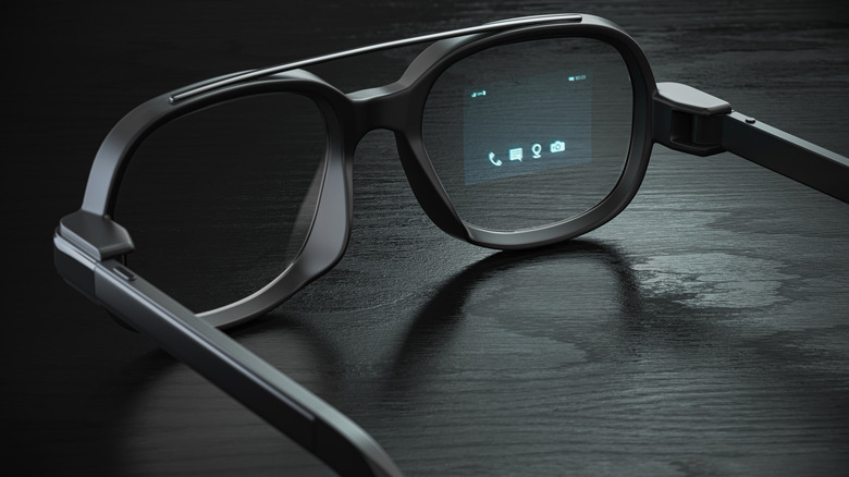 A set of augmented reality glasses with a small projected display visible in one lens.