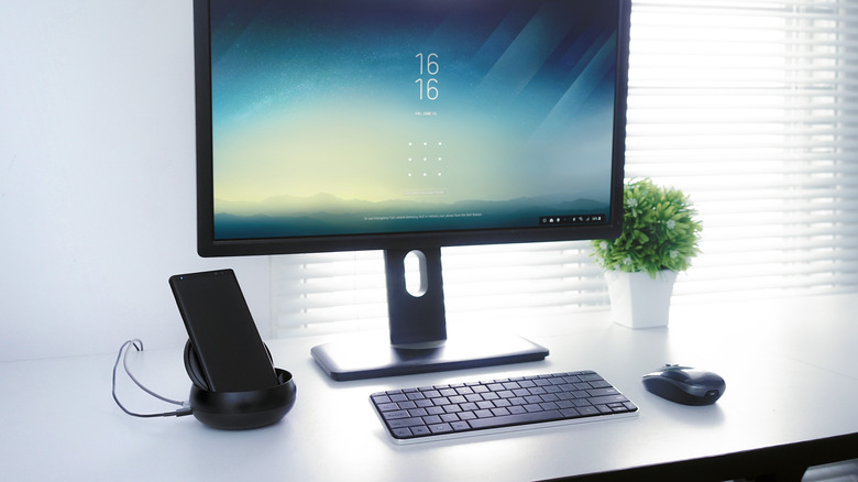 A Samsung Galaxy phone connected to a DeX station.