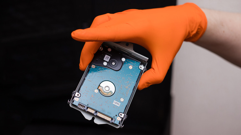 Someone holding a hard drive