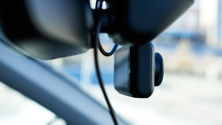 Close-up of a dash camera mounted inside a vehicle.