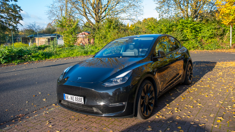 A black Tesla Model Y parked on the street