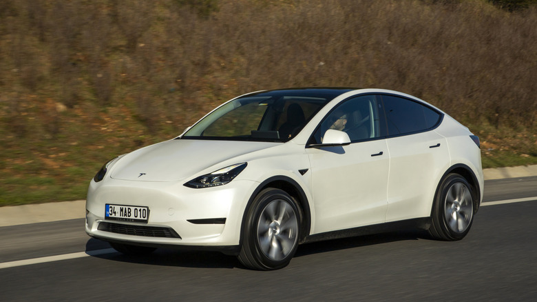A white Tesla Model Y on the highway
