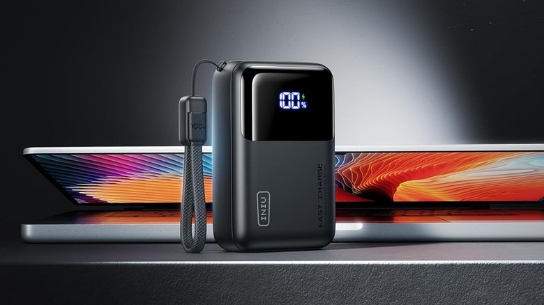 The INIU Cougar P62-E1 power bank with a laptop behind it.