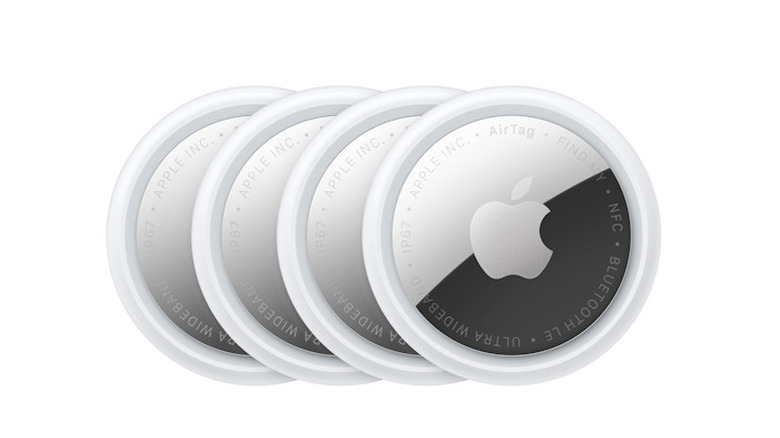 Four Apple AirTag Gen 2s stacked on top of each other