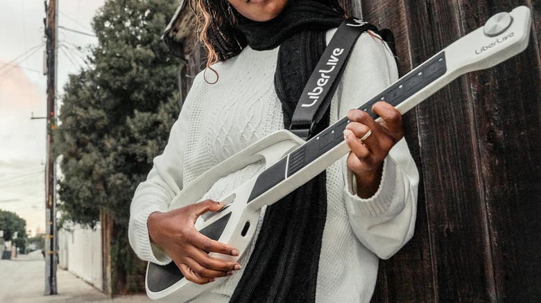 A person playing the LiberLive C2 stringless guitar