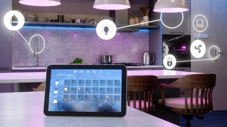 Modern kitchen interior with smart control tablet on table