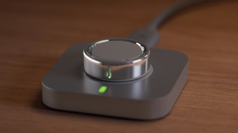 The Oura Ring 4 smart ring on its charging dock.