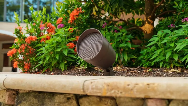 A speaker of the VOLT OHM 4.1 outdoor audio system, installed in a flower bed.