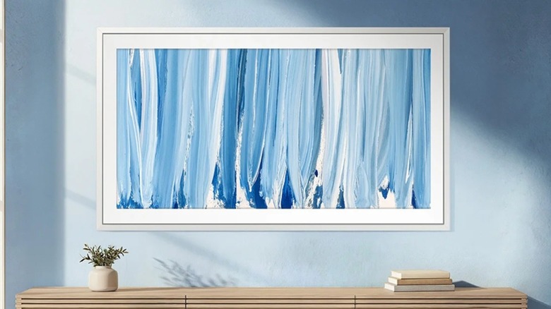 The Samsung The Frame Pro Series Neo QLED 4K TV mounted on a wall.