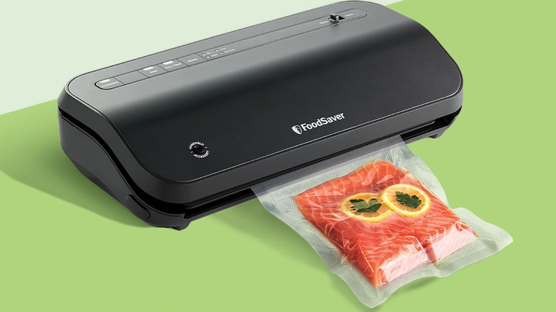 FoodSaver vacuum sealing system sealing s salmon fillet in a plastic bag