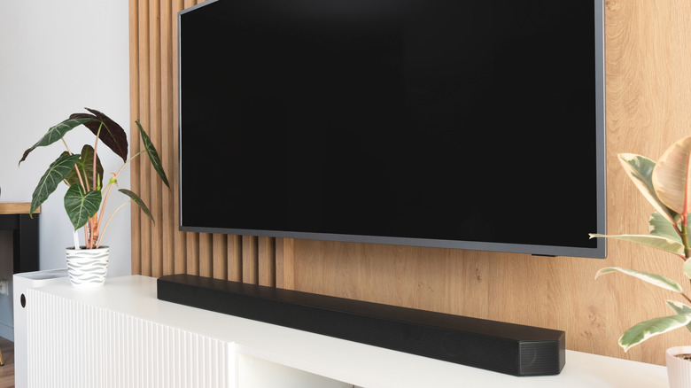 A soundbar placed in front of a TV.