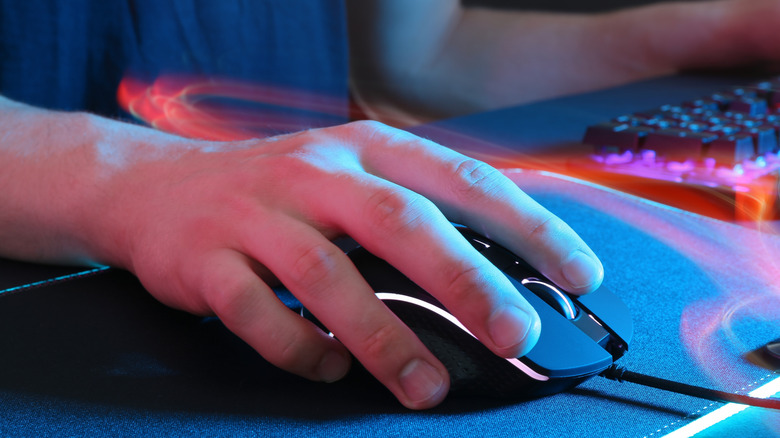 Closeup of a hand placed on a computer mouse