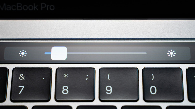 A picture of a brightness control slider above a laptop keyboard