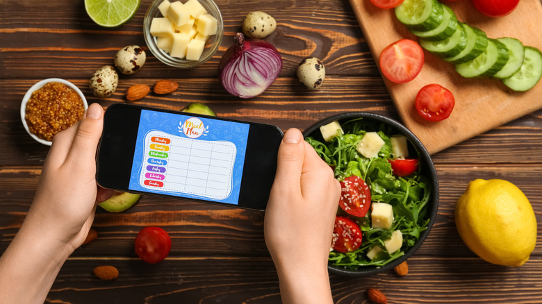 A person using an app to create a meal plan.