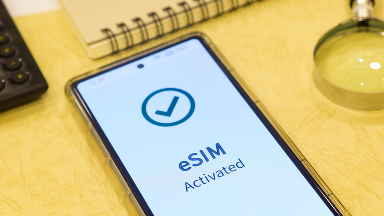 A smartphone showing a message on its screen indicating that an eSIM was activated.